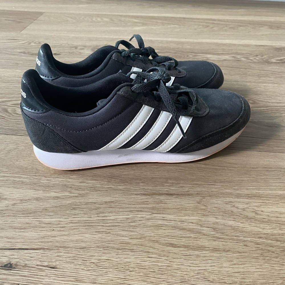 Blue Adidas with white stripes